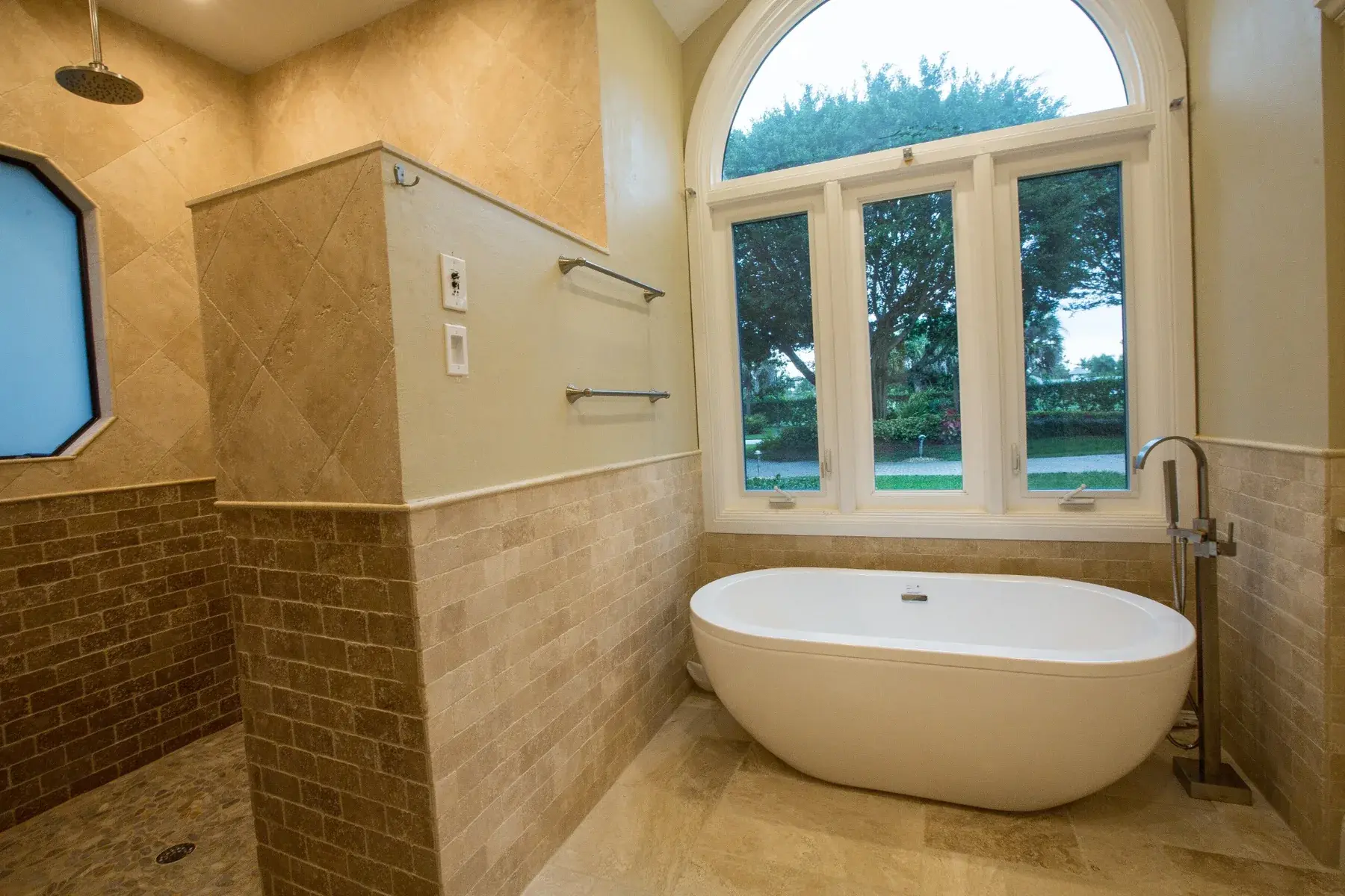 Completed Southwest Florida primary bathroom with freestanding tub and stone shower