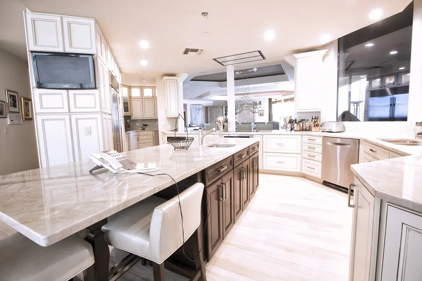 Completed Southwest Florida condo kitchen with a large island and mixed cabinetry